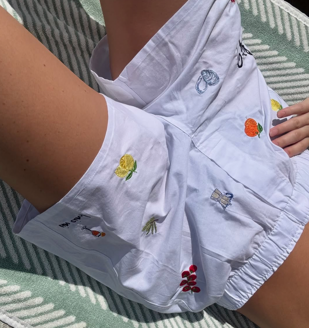 woman wearing Italian summer patchwork boxers with lemons shells cocktail mocha pot oranges