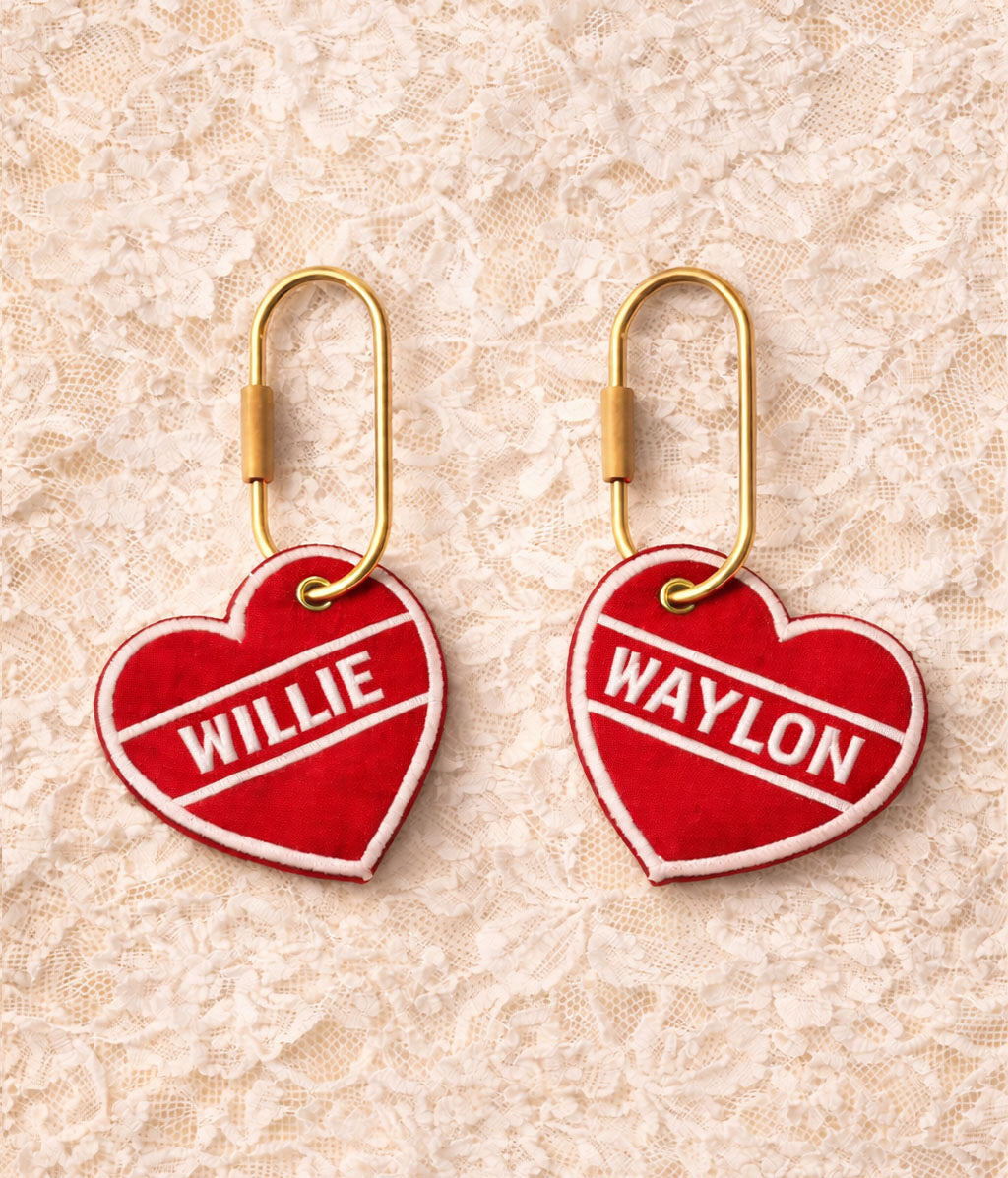 Two red heart-shaped tags with 'Willie' and 'Waylon' on a beige lace background