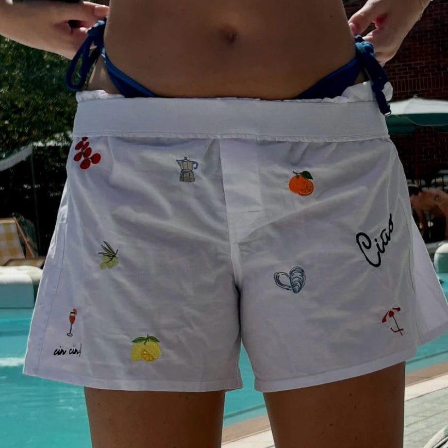 woman wearing Italian summer patchwork boxers with lemons shells cocktail mocha pot oranges
